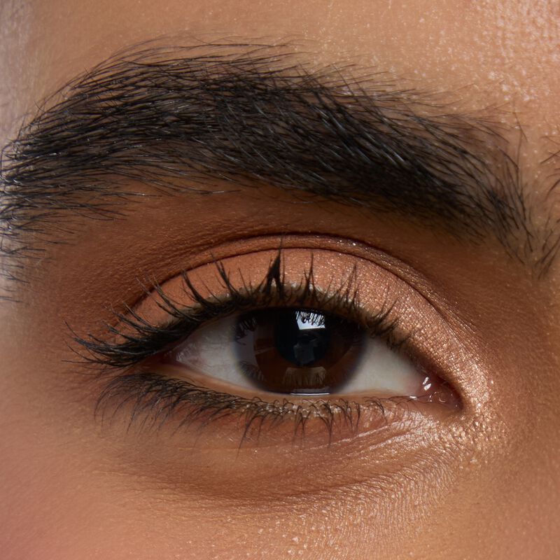 Mediumskinned model wearing Mary kay Eye Shadow Sticks in shades Golden Sunrise and Orbit Clay